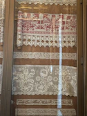 a window with a curtain and lace on it