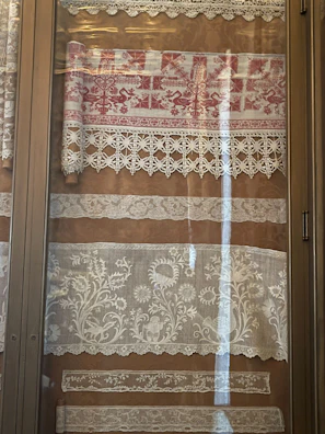 a window with a curtain and lace on it