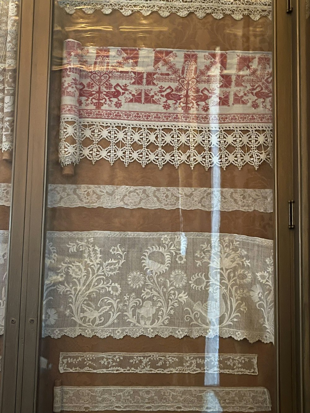 a window with a curtain and lace on it