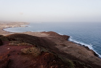 A scenic coastal land with ocean views and sandy shores.