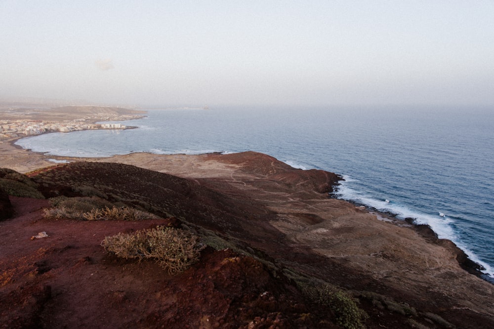 a view of the ocean from the top of a hill