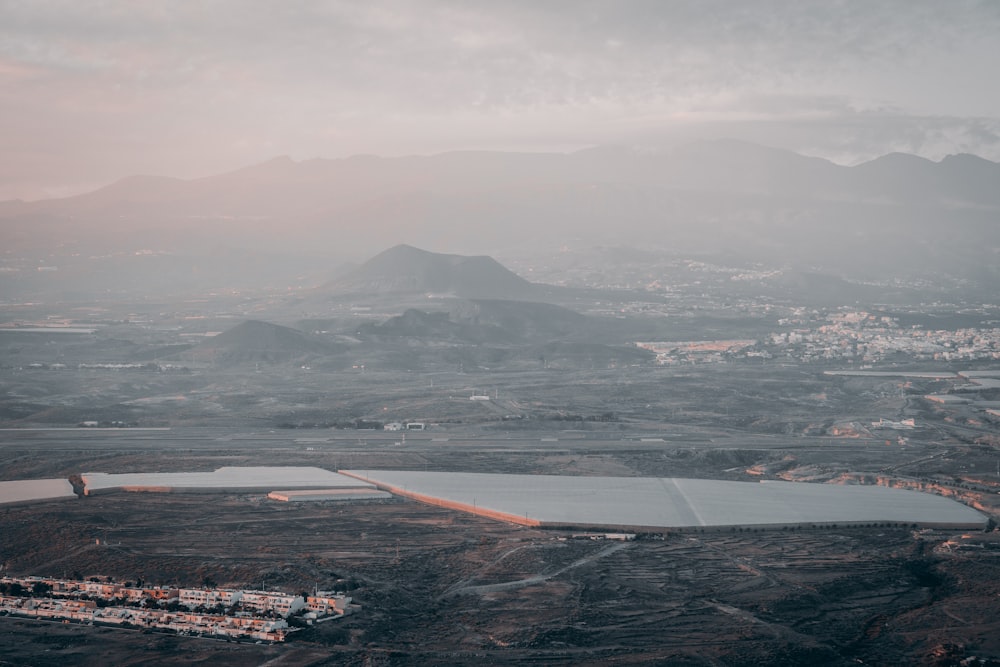 an aerial view of a large lake surrounded by mountains