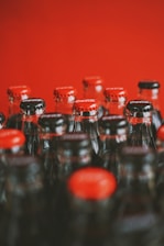 a close up of many bottles of soda