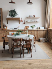 A vibrant kitchen scene featuring colorful storage organizers, utensils, and a cozy dining setup bathed in natural light.