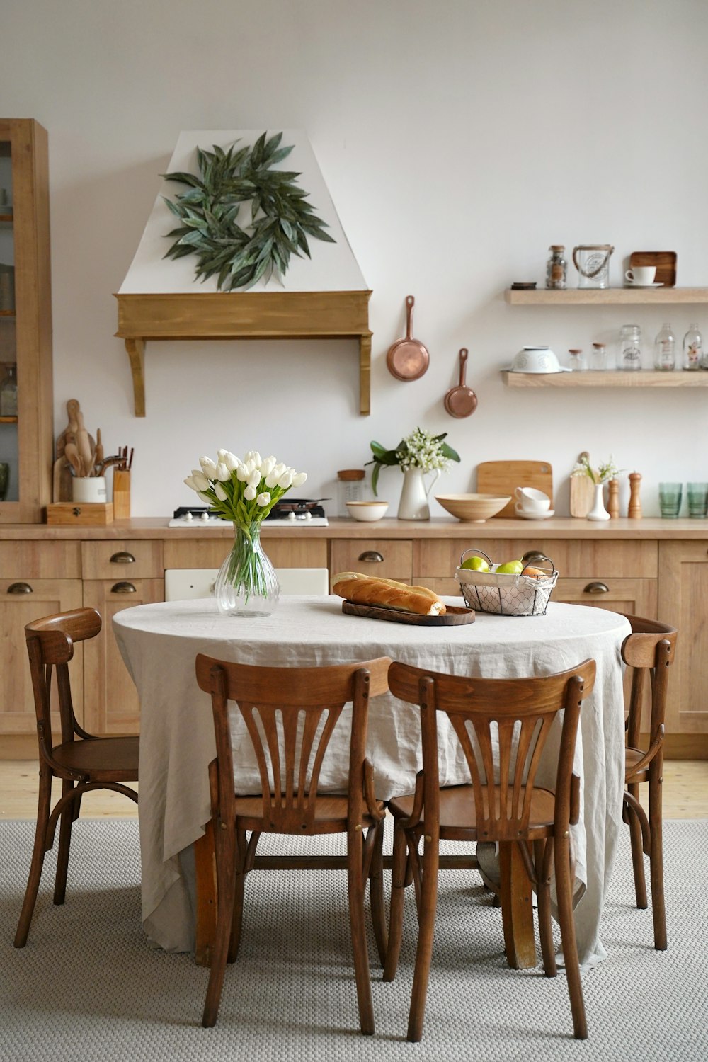 a kitchen with a table and chairs and a potted plant