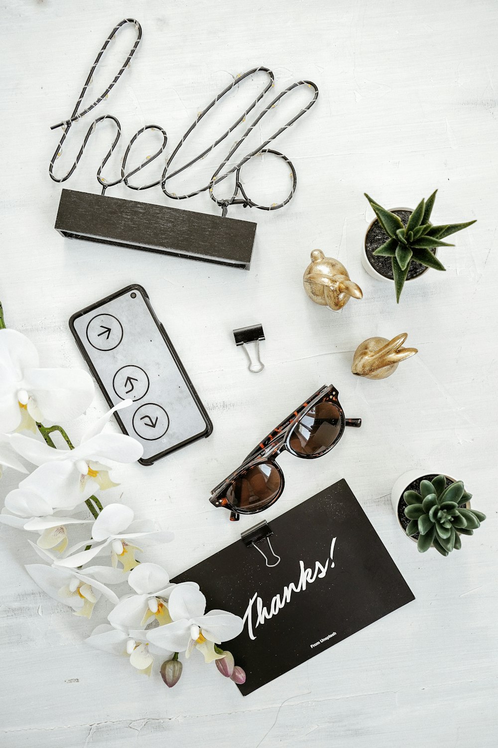 a white table topped with white flowers and sunglasses