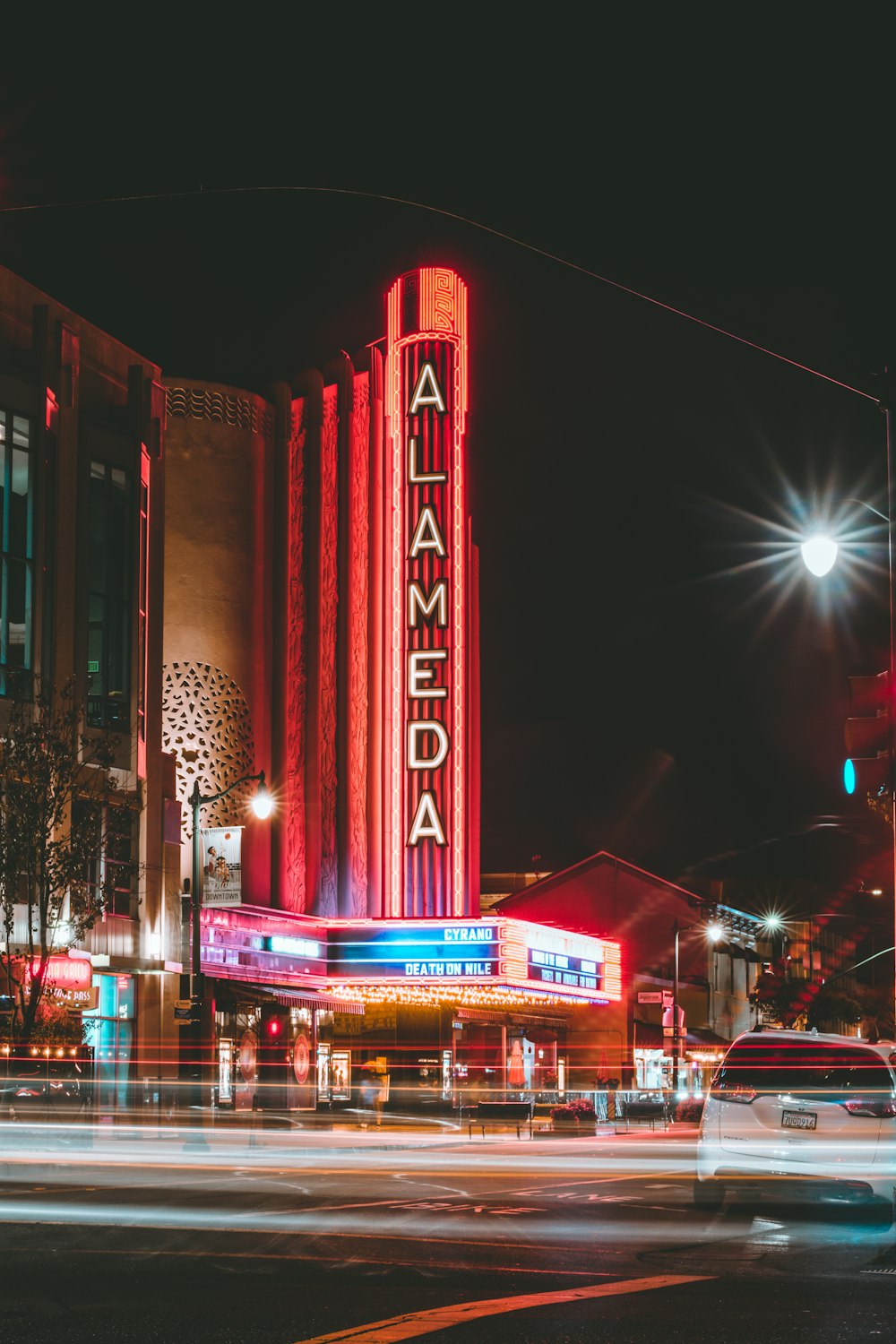 a large building with a neon sign on the side of it