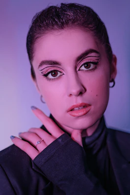 a woman in a black suit with a ring on her finger