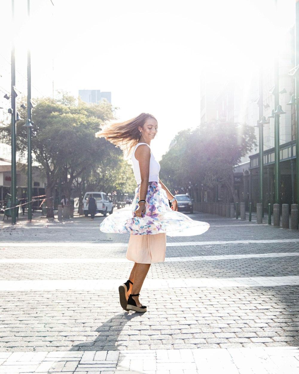 a woman walking down a street with a dress on