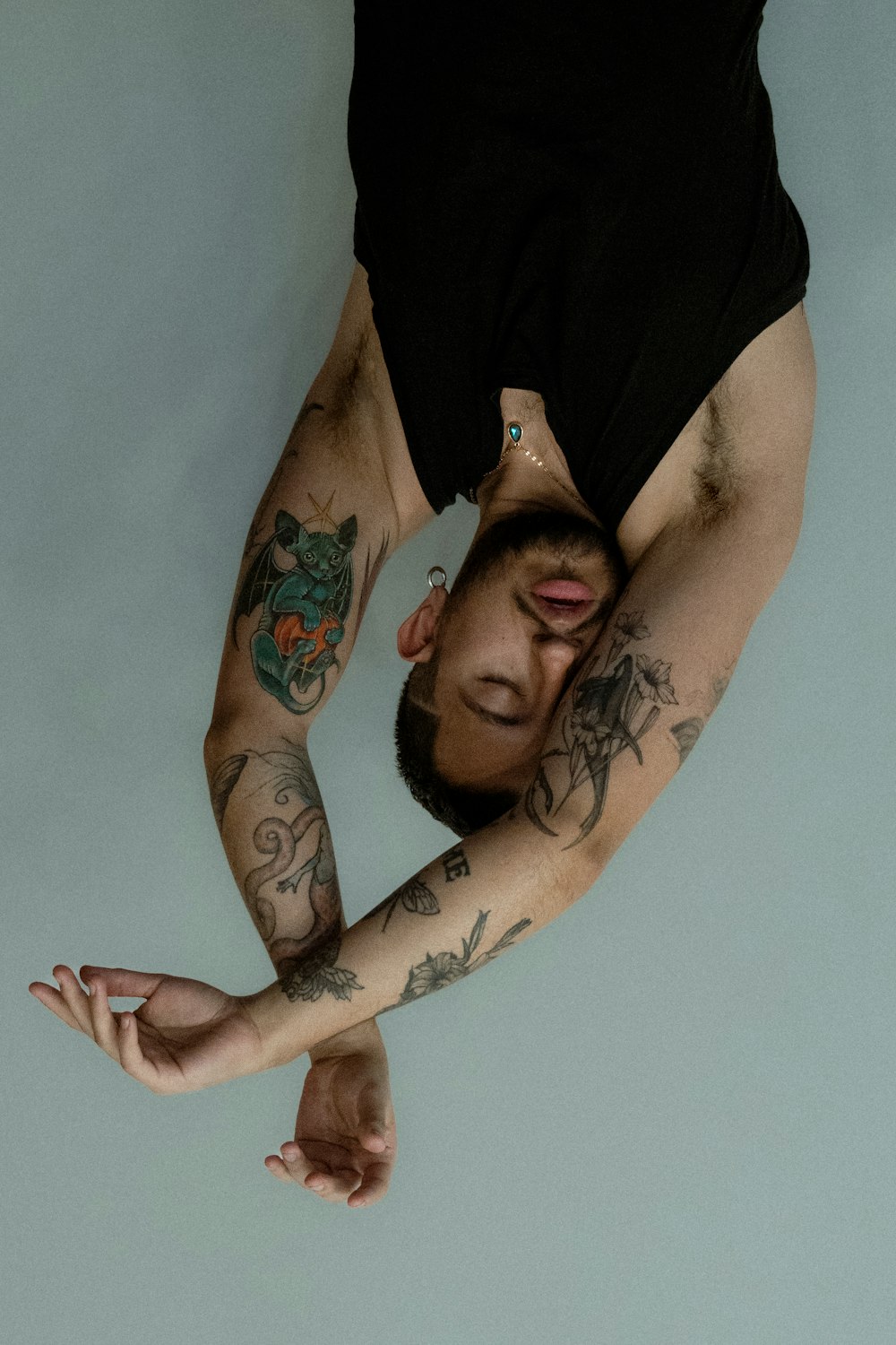 a man with tattoos on his arms and arms