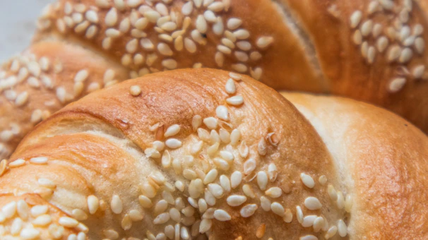 Close-up of freshly baked Moroccan bread with sesame seeds, golden and inviting.
