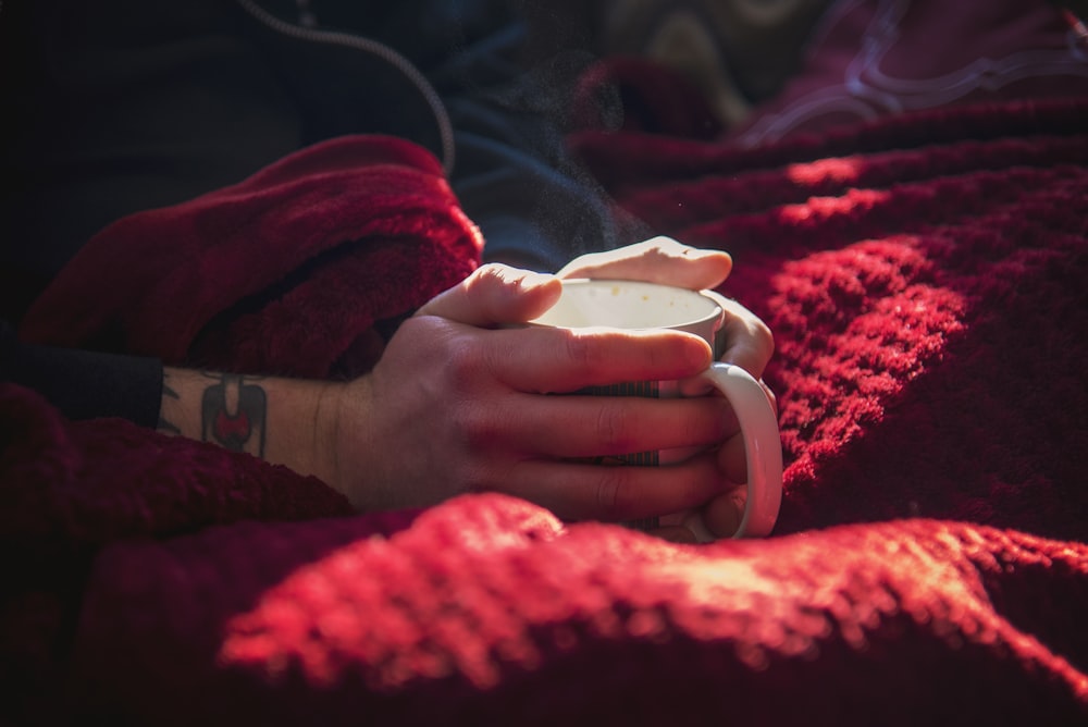 a person holding a cup in their hands