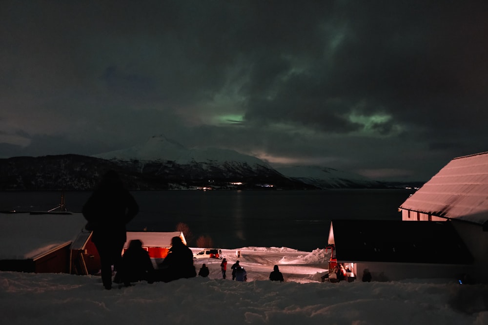 a group of people standing on top of snow covered ground