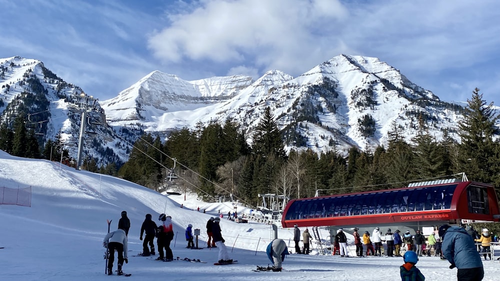 a group of people standing on top of a snow covered slope