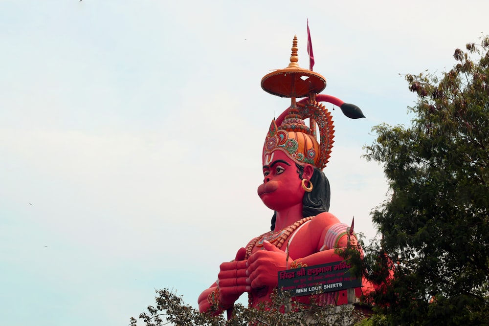 a large statue of a person with a hat on top of it