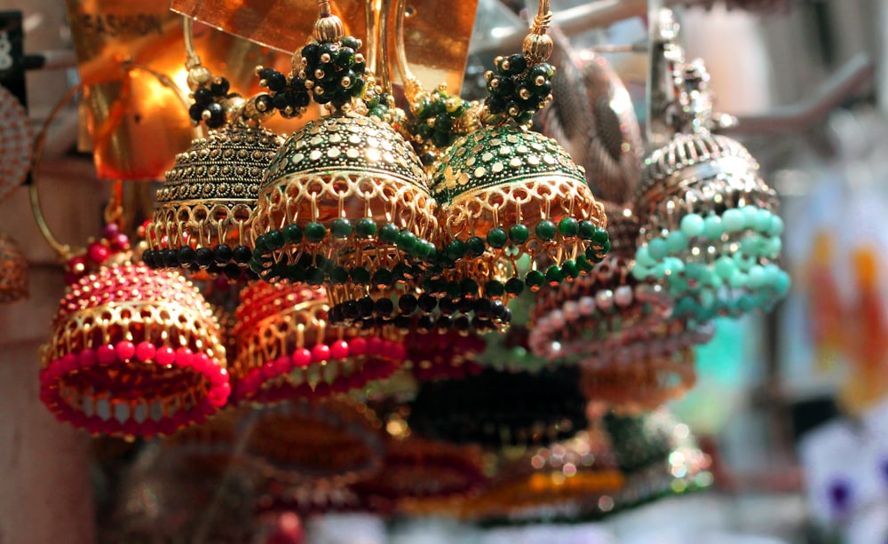 a bunch of colorful ornaments hanging from a ceiling