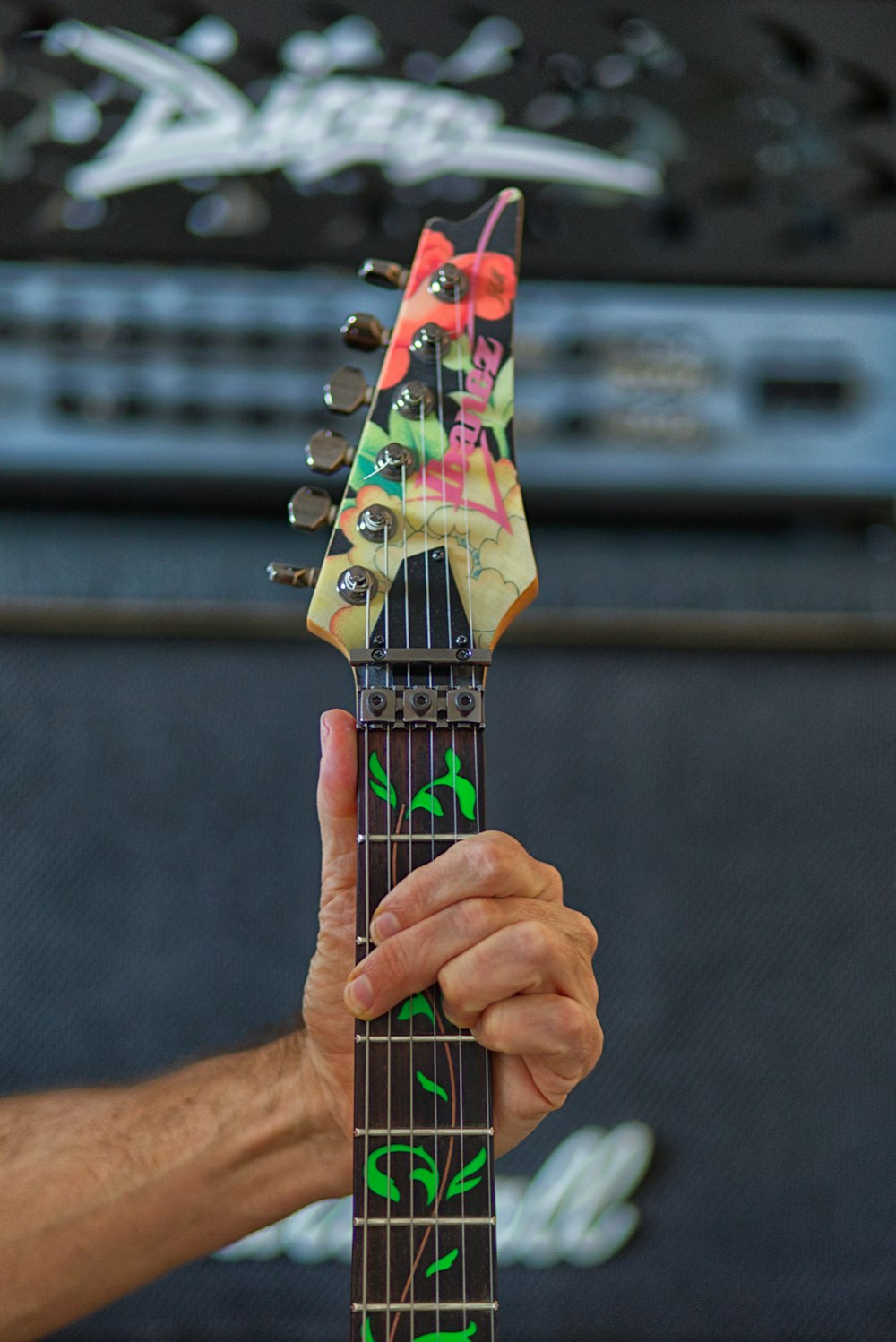 a person holding a guitar in their hand