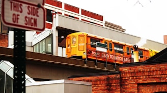 a yellow bus is going over a bridge