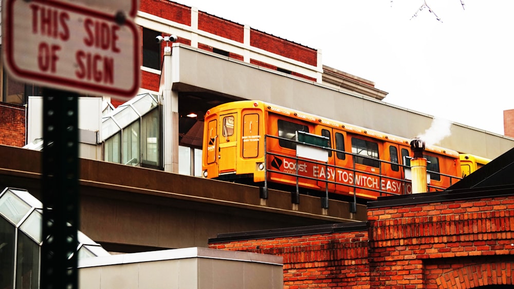 a yellow bus is going over a bridge