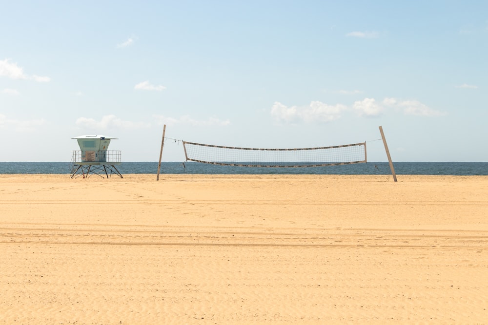 a volleyball court with a net on the beach
