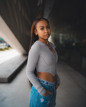 A high-fashion model posing confidently against an urban backdrop.