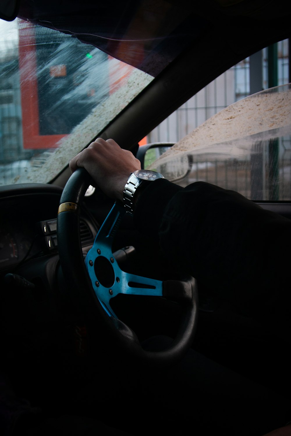 a person driving a car in the rain