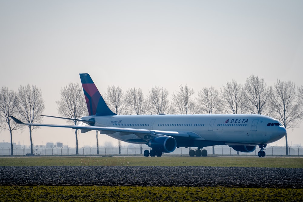 a large jetliner sitting on top of an airport runway