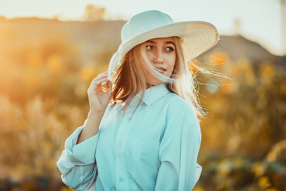 a woman wearing a white hat and blue shirt