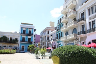 a row of multi - colored buildings on a sunny day