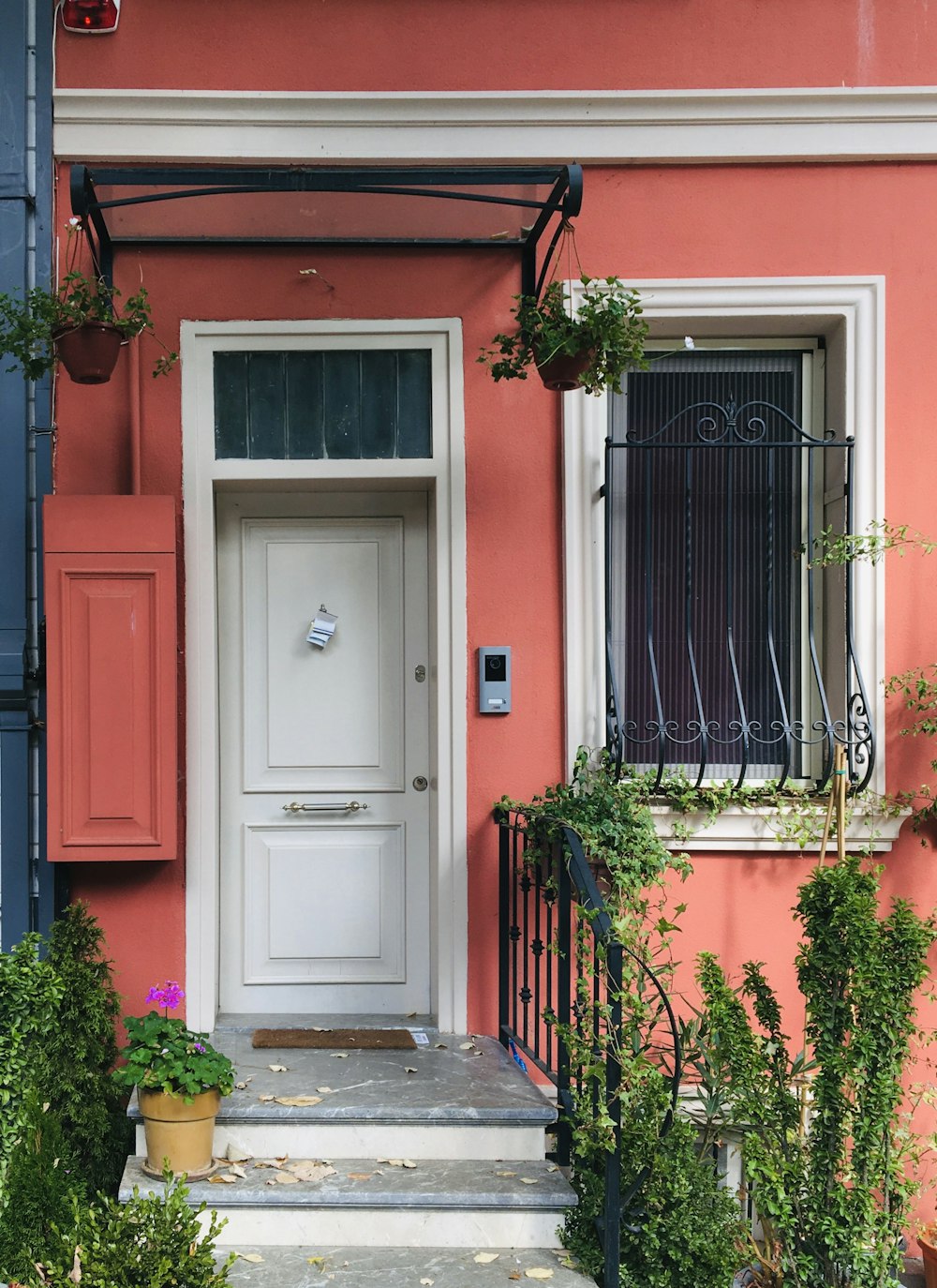 a house with a white door and some plants