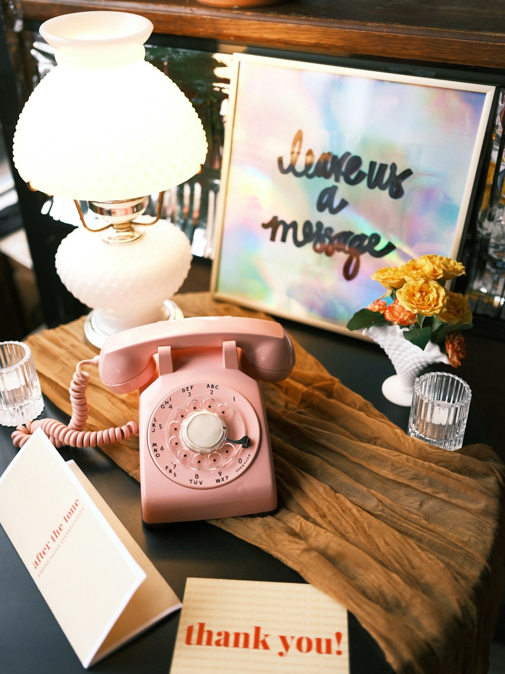 a pink phone sitting on top of a wooden table