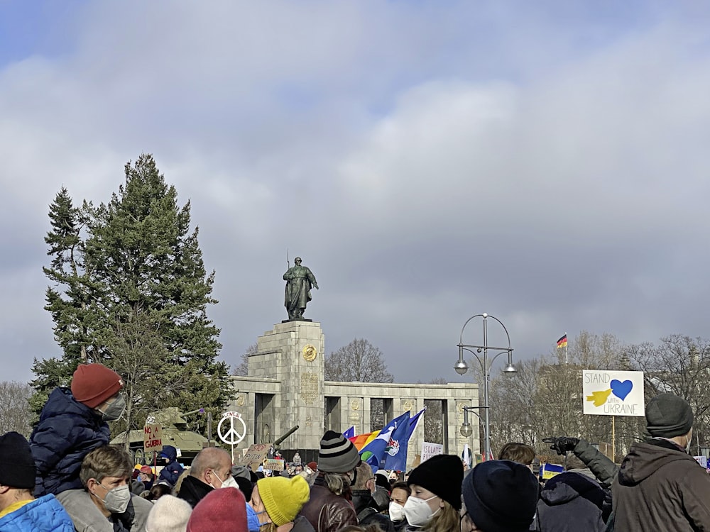 a crowd of people standing around a statue