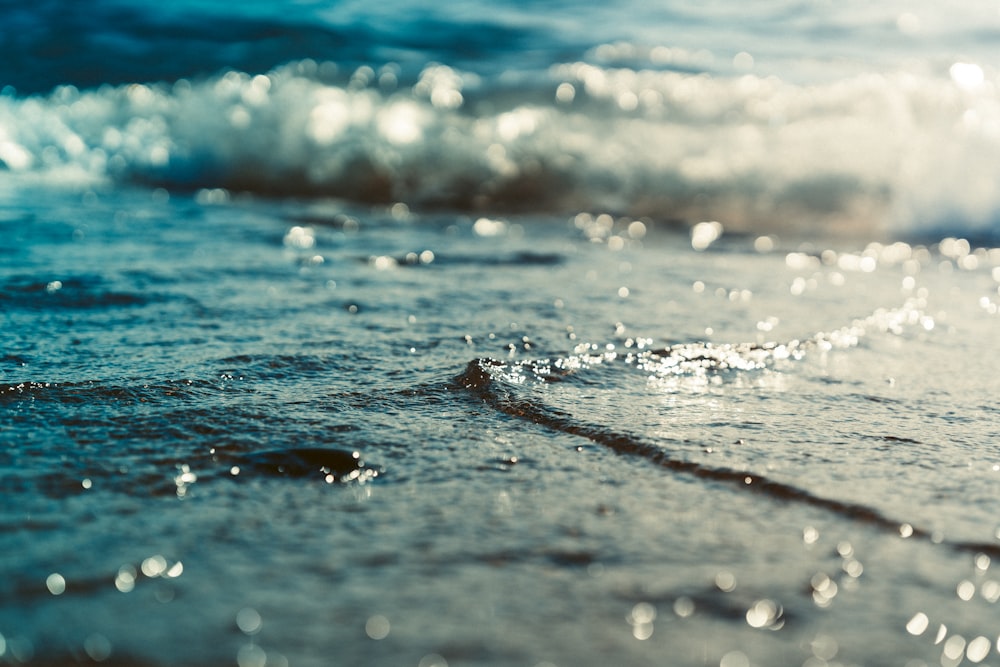 a close up of water and sand on a beach