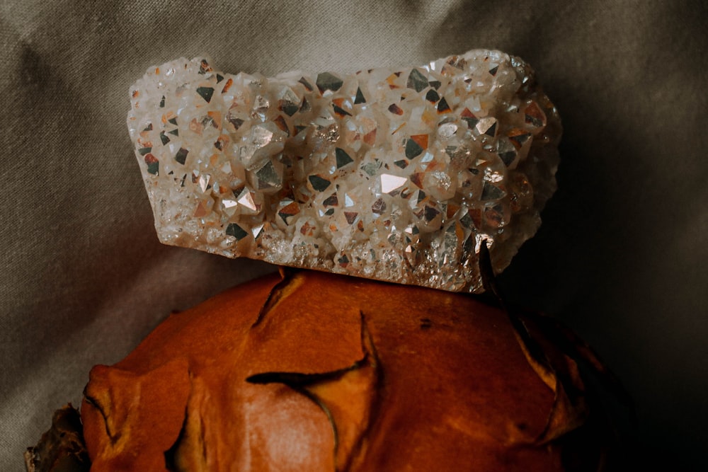 a piece of jewelry sitting on top of a pumpkin