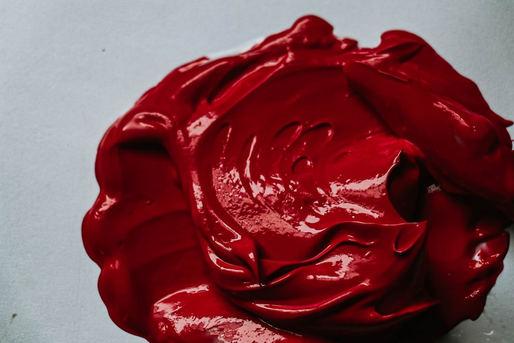 a close up of a red substance on a white surface