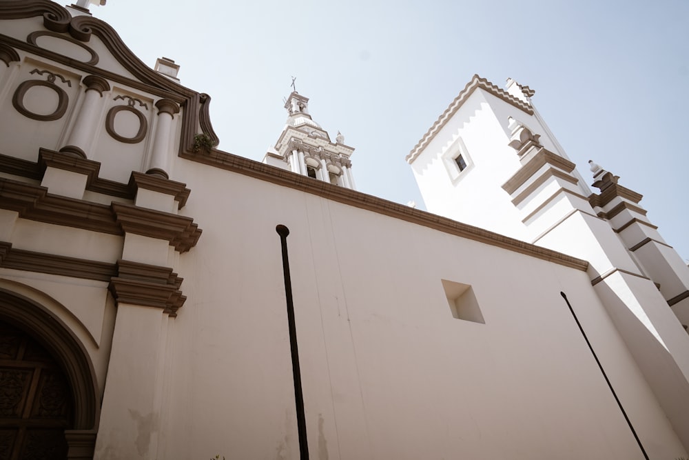 a tall white building with a clock on it's side