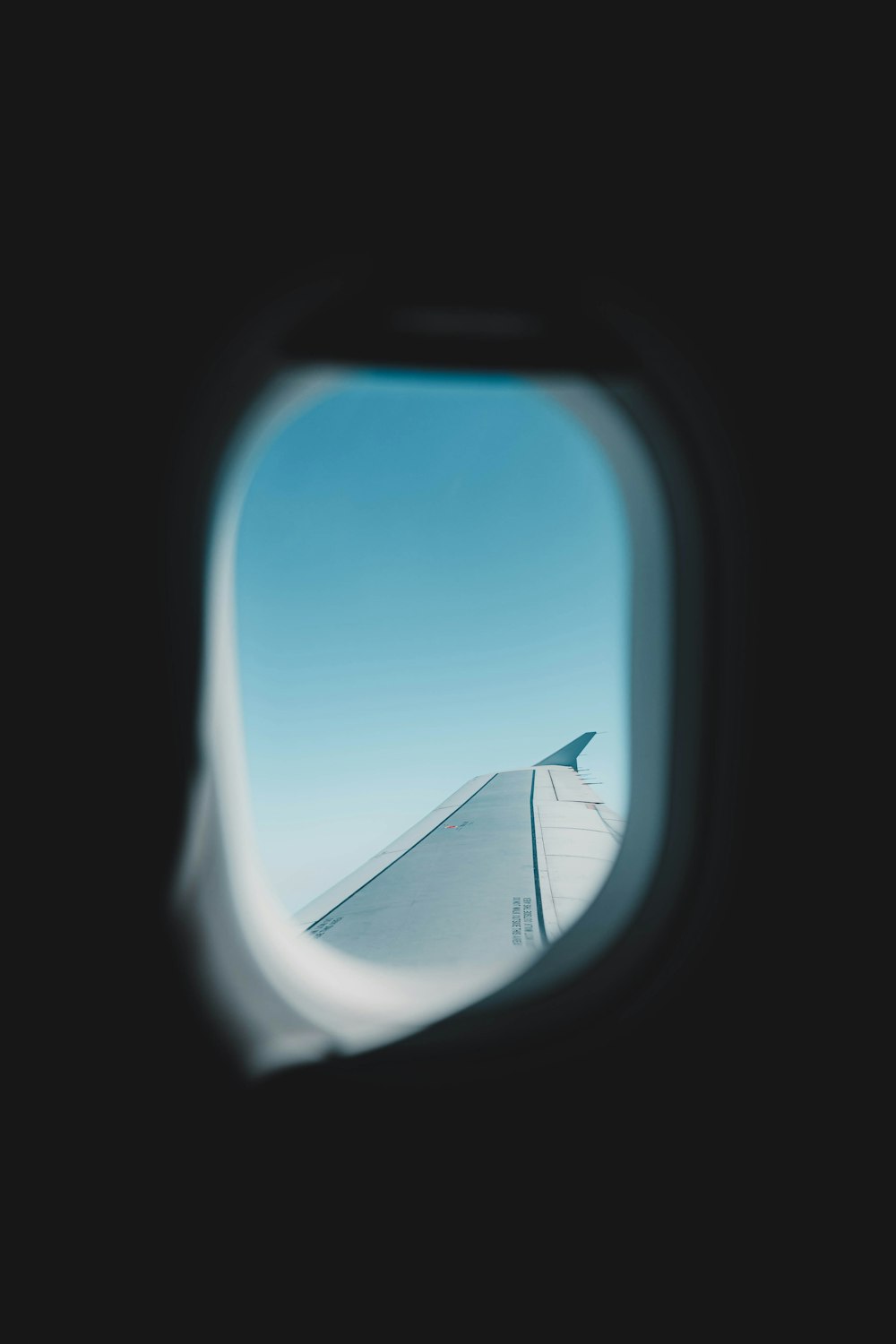 a view of the wing of an airplane through a window