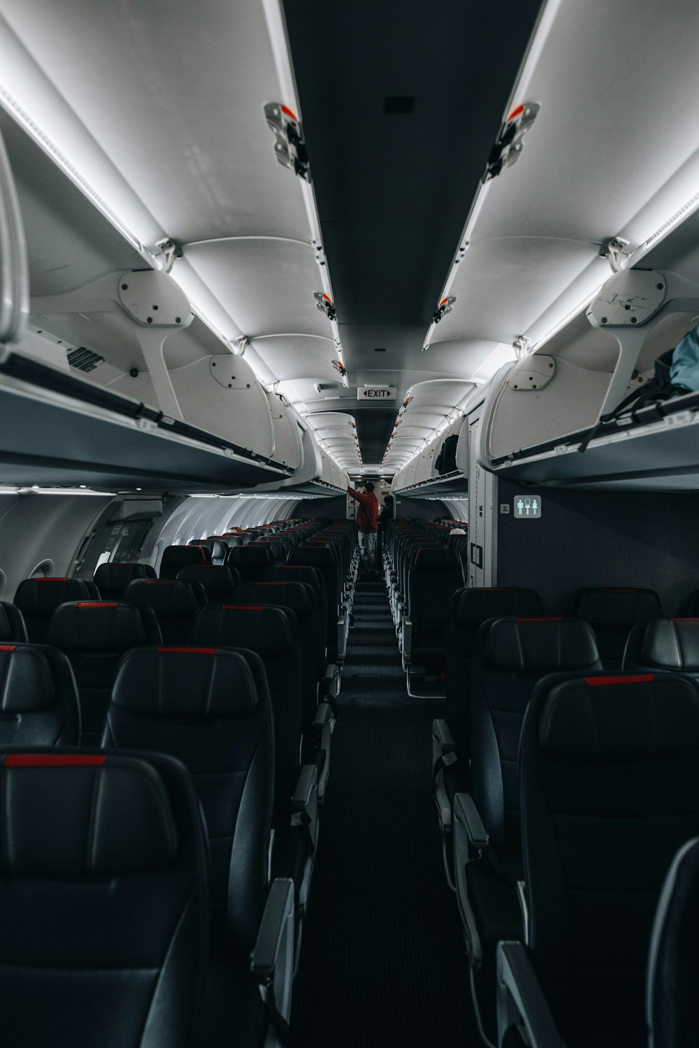 the inside of an airplane with rows of seats