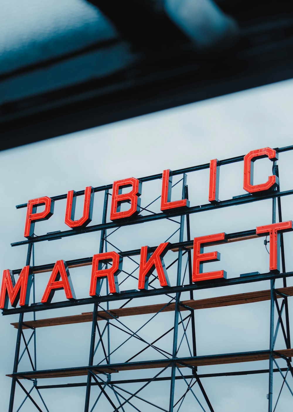 a public market sign on top of a building