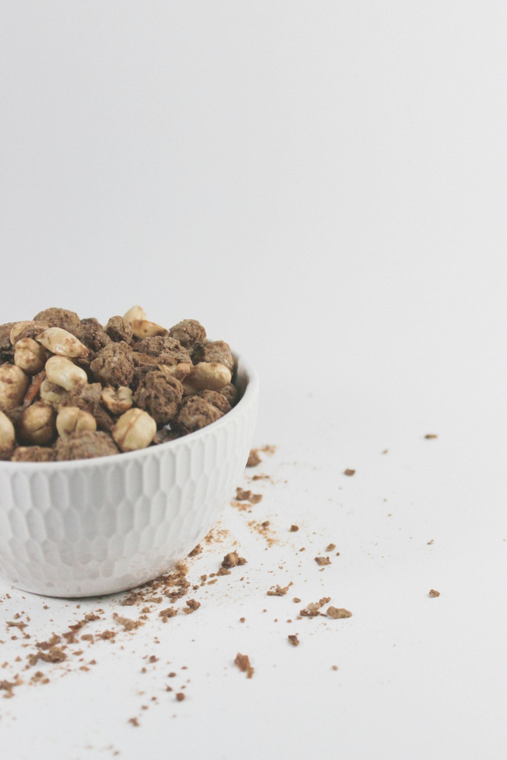 a white bowl filled with cereal on top of a table