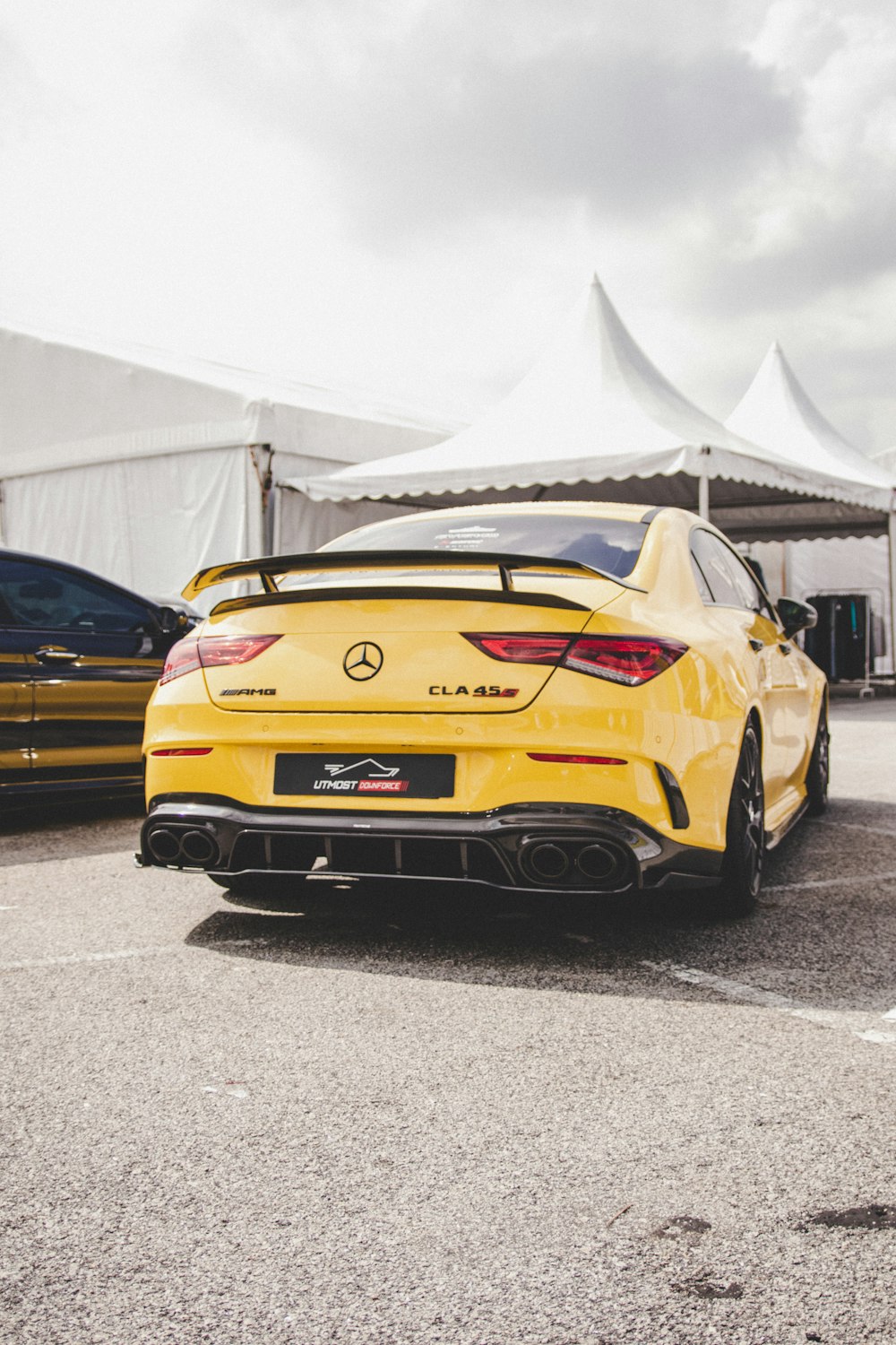 a yellow sports car parked in a parking lot