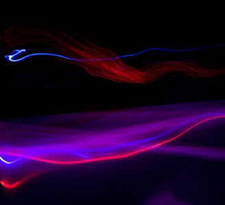 a blurry photo of a black background with red and blue lights