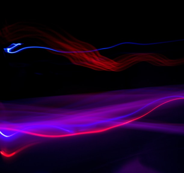 a blurry photo of a black background with red and blue lights