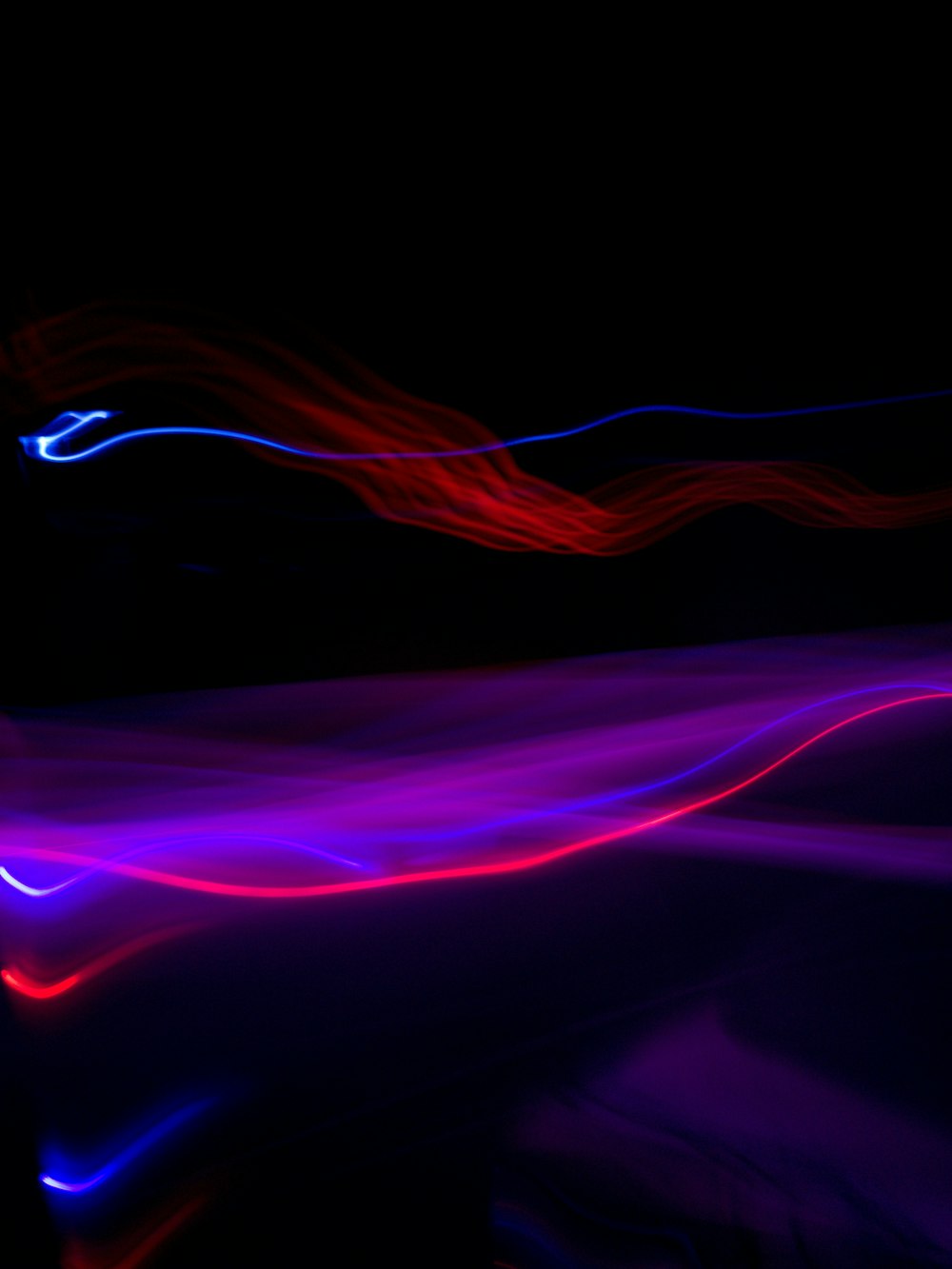 a blurry photo of a black background with red and blue lights