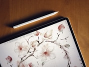 a tablet with a painting of flowers on it