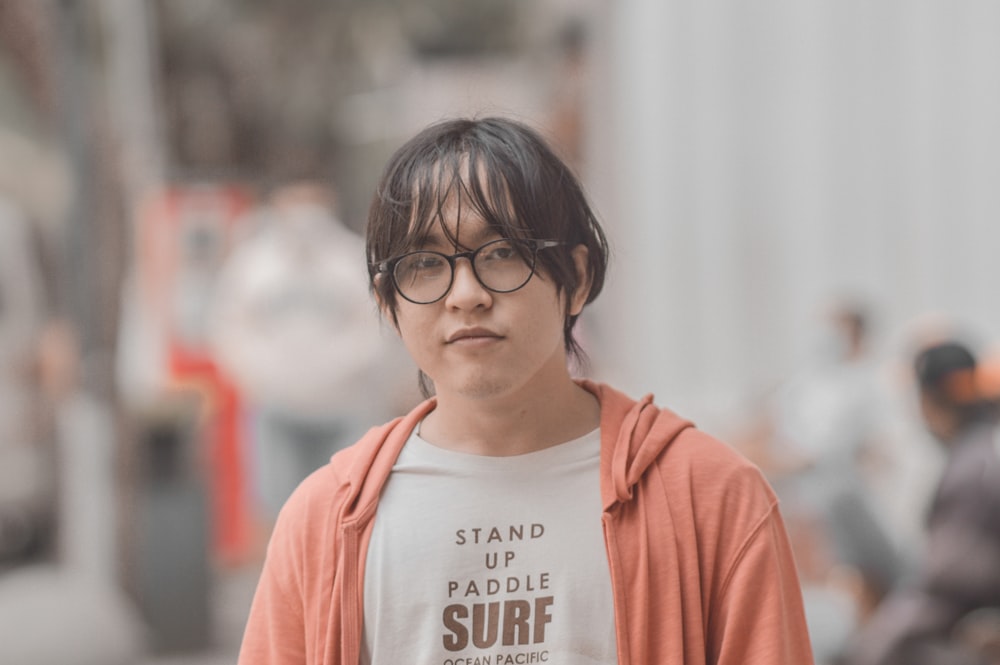 a young man wearing a t - shirt that says stand up paddle surf