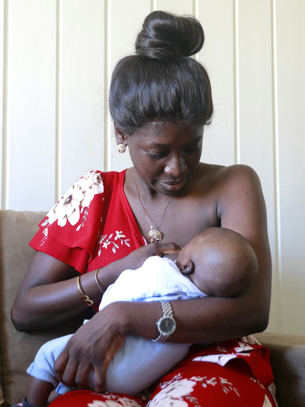 a woman holding a baby in her arms