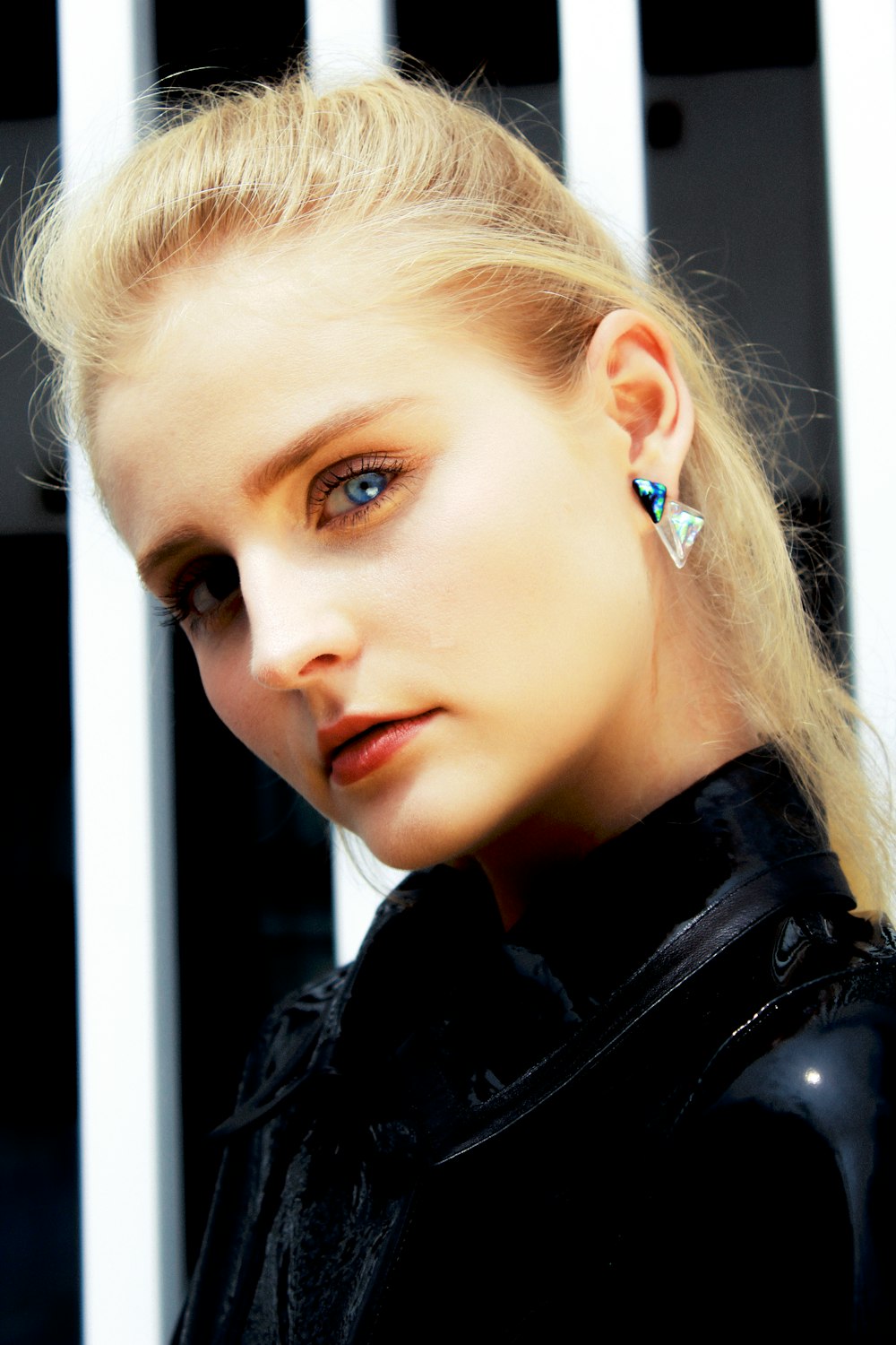 a woman with blue eyes wearing a black jacket
