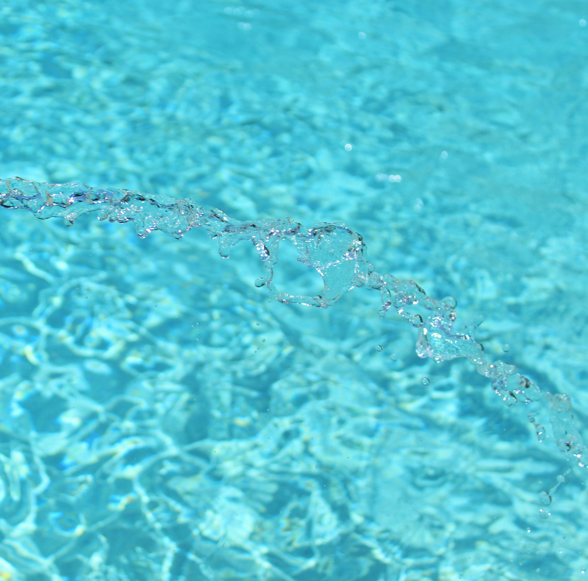 a blue pool with clear blue water