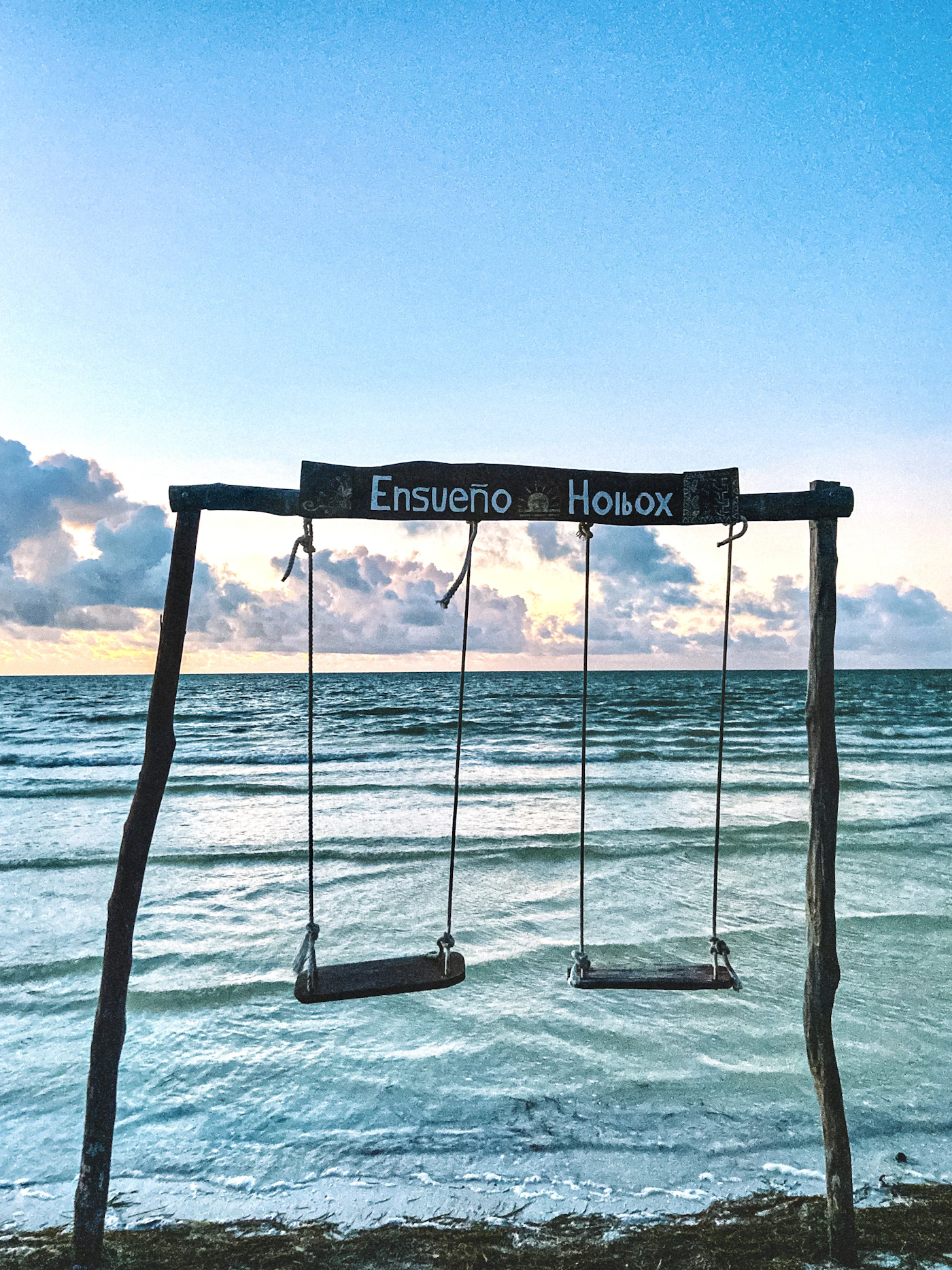Two swings suspended in the turquoise water at Hotel Ensueno on Holbox island Quintana Roo Mexico showing the characteristic shallow Caribbean lagoon character